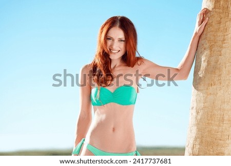Portrait, smile and woman in bikini on tropical vacation or luxury holiday at hotel with blue sky. Travel, summer and palm tree with happy young person outdoor to relax in swimwear on island getaway