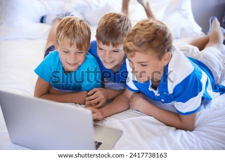 Children, siblings and boys on a bed with laptop for streaming, movie or video at home bonding. Family, watching and kids in a bedroom with pc, internet or search for social media, gaming or cartoon