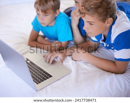 Kids, siblings and boys on a bed with laptop for streaming, movie or video at home bonding. Family, watching and children in a bedroom with pc, internet or search for social media, gaming or cartoon