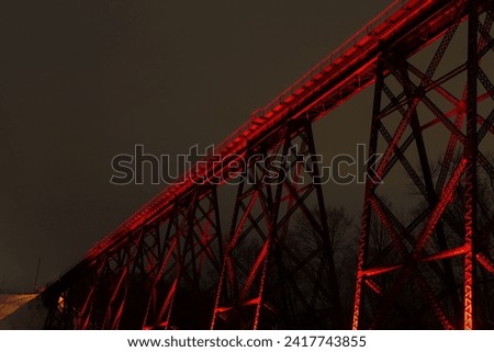 View of the illuminated 1908 railway trestle bridge seen from Chaudière boulevard during a winter evening, Cap-Rouge area, Quebec City, Quebec, Canada Royalty-Free Stock Photo #2417743855