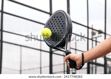 paddle tennis racket hitting ball. close- up on the racket Royalty-Free Stock Photo #2417748383