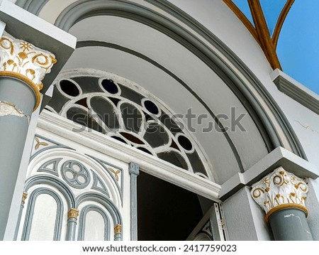 Background of a church front door. Baroque style brought by colonizers to Brazil. Cultural heritage. Arch, circles and element details decorating the building. Catholic templein south of Brazil.