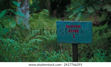 Buffer zone notice board in the forest Royalty-Free Stock Photo #2417766291