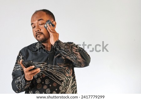 handsome man holding smartphone and expression in white background isolation