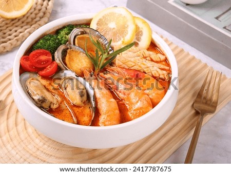 Seafood Tom yum kung. Tom Yum Goong Yai Spicy Giant Tiger Prawn Soup, Lemongrass,Lime Juice, Bird’s Eye Chilies Royalty-Free Stock Photo #2417787675