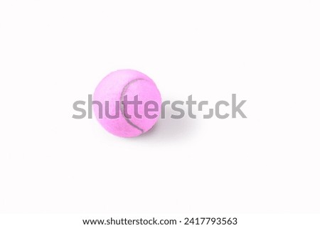 Pink tennis ball with shadow on a white  background. Simple stop motion sport animation Royalty-Free Stock Photo #2417793563