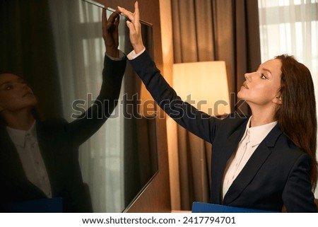 Expert housekeeping supervisor inspecting guest suite after cleaning Royalty-Free Stock Photo #2417794701