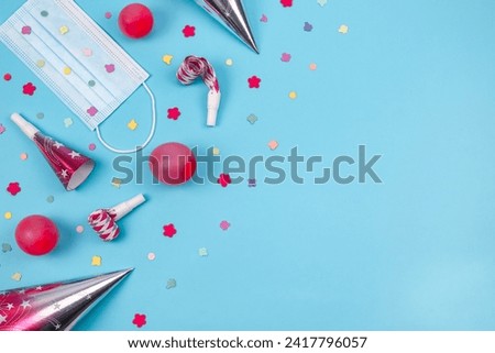 Set of medical mask, birthday cone, confetti balls on a blue background.
