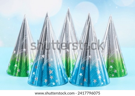 Set of cone birthday hats on a blue background.