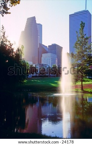 Downtown Houston, Texas with water fountain and pond reflection.
