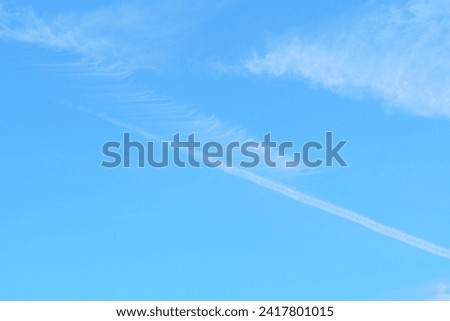 picture of the sky with airplane clouds