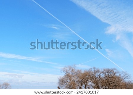 picture of the sky with airplane clouds