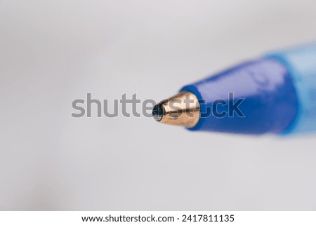 Macro Close-up of a Precise Blue Ballpoint Pen Tip, a Versatile Writing Instrument for Office Supplies, Note Taking, and Creativity Royalty-Free Stock Photo #2417811135