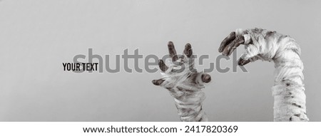 Mummy hands wrapped in a bandage isolated on a black background. Halloween concept. Copy space