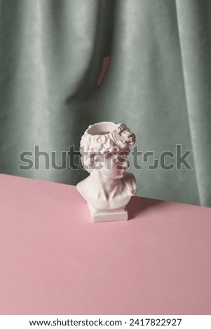 Bust of David against the background of a curtain. Aesthetic still life. Minimalism. Holiday mood Royalty-Free Stock Photo #2417822927