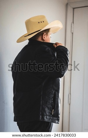 Cowboy in cowboy hat and black leather jacket