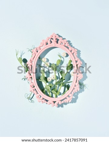 Young peas in an oval vintage picture frame, a creative composition, a combination of nature and elements of retro style.