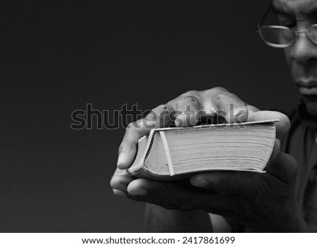 black man praying to god Caribbean man praying with black background with people stock photo