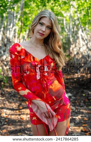 Stunning model graces Central Mexico's mangrove fields in a picturesque vacation pose, blending natural beauty with serene surroundings.