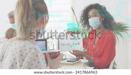 Image of digital interface showing statistics with colleagues in office wearing face masks. Healthcare and protection during coronavirus covid 19 pandemic, digitally generated image