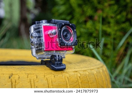 Action camera in a protective box for shooting dynamic videos.