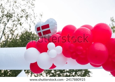 Danish flag with red and white balloons. Symbols of Denmark.
