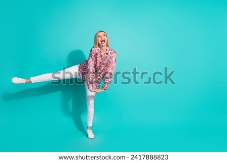 Full size photo of impressed funny girl wear oversize shirt danicng look at discount empty space isolated on turquoise color background