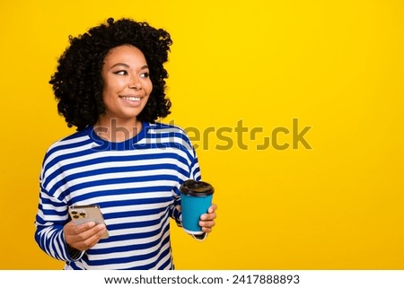 Photo of adorable lovely girl wear trendy clothes drink tasty beverage latte look empty space isolated yellow color background