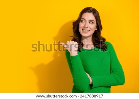 Photo of lovely cute woman dressed green stylish clothes recommend boutique empty space isolated on yellow color background