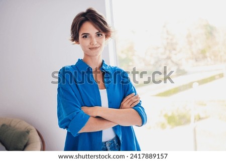 Photo of confident successful woman realtor standing in room showing modern flat
