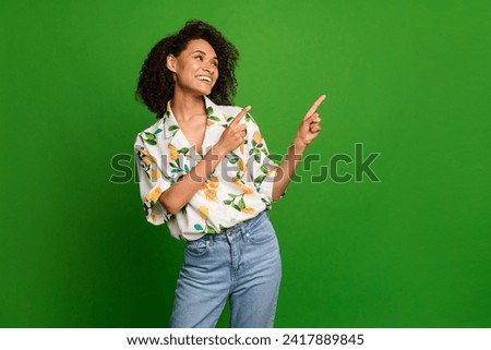 Photo of pretty thoughtful woman dressed print shirt looking pointing two fingers empty space isolated green color background