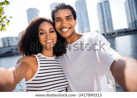 Photo of positive glad attractive people wife husband walking in downtown webcam streaming sunny day sunlight outside