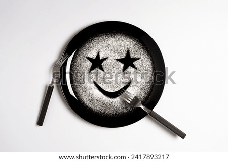 Smiling face, concept made with plate and flour, white background, star shaped eyes, black plate, happy mood, facial expressions, forks in the shape of arms with different positions