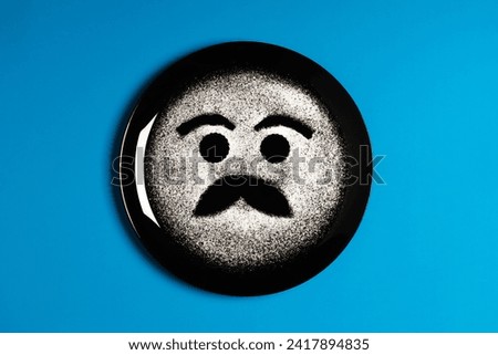 Smiling face, concept made with plate and flour, cyan background, star shaped eyes, black plate, happy mood, facial expressions