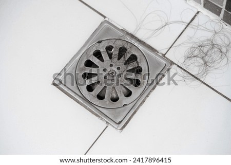 Close-up Pile of hair loss in bathroom after wash hair.hair fall everyday serious problem, on white background.Solutions for hair loss. Royalty-Free Stock Photo #2417896415