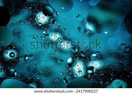 Oil on water abstract bubbles background macro close up texture blue green astronomy