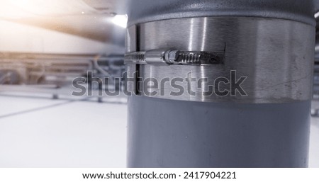 Clamp the air pipe connection with the tightening adjustment bolt. Royalty-Free Stock Photo #2417904221