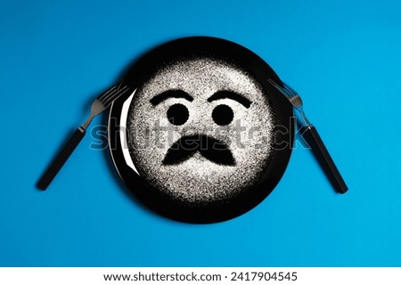 Happy face, face with mustache, concept made with plate and flour, blue background, black plate, facial expressions, forks in the shape of arms with different positions