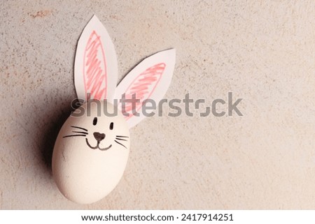 Photograph of an egg with bunny ears. Easter concept.