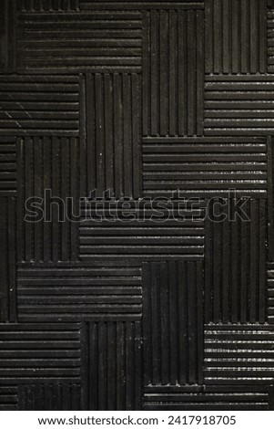 A mesmerizing abstract photograph captures the essence of a mysterious labyrinthine wall. Dark hues intertwine, creating a complex web of shadows that beckon the viewer to explore the enigmatic depths
