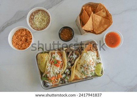 tacos and chips on a white marble background