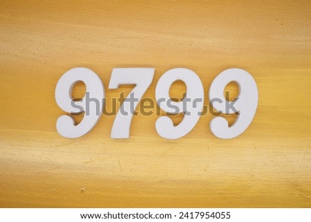 The golden yellow painted wood panel for the background, number 9799, is made from white painted wood.