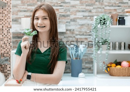 Portrait of face young female caucasian beautiful woman blond hair smiling with braces. Happy girl in good mood smile showing teeth looking at camera.