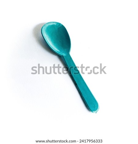 Small blue plastic spoon, ice cream spoon, pudding spoon isolated on white background