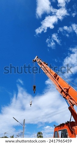 Construction  with crane Blue sky white clound orange crane Royalty-Free Stock Photo #2417965459