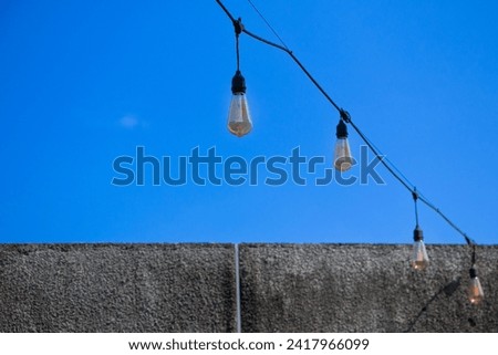 Low angle view of outdoor bulb lamp in luxury hotel decoration with clear blue sky in the background