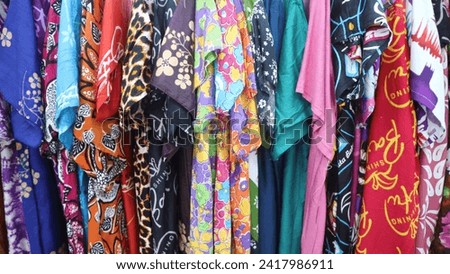 Various colored textile hanging on the rack in a store for sale, colorfull background