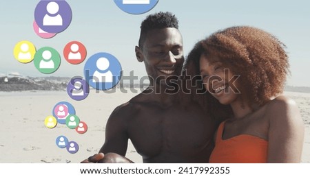 Image of social media people icons over smiling couple in love on beach. digital interface, social media and global network concept digitally generated image.