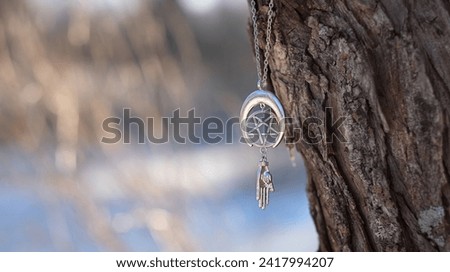 amulet with pentagram on tree, abstract natural forest background. spiritual ritual. witchcraft, pagan traditions, wiccan practice. esoteric symbol of pentacle and hand. copy space Royalty-Free Stock Photo #2417994207