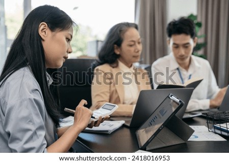 Group of Young Asian business team creative businesspeople coworker in office. Meeting Presentation for analysis graph company financial. People Work in Business Office.